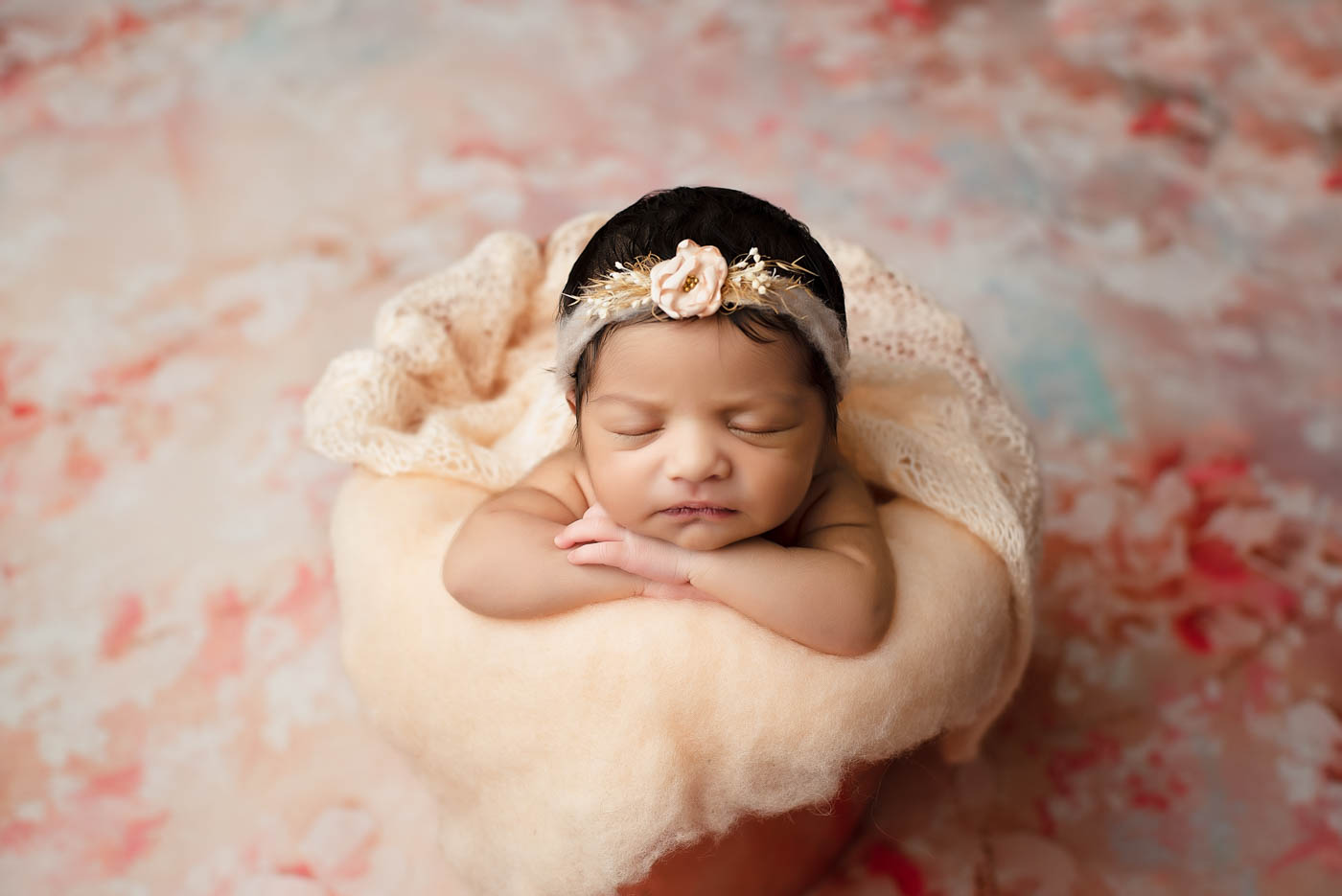 Sleeping Newborn Posed In A Bowl Using Classic Newborn Photography Props