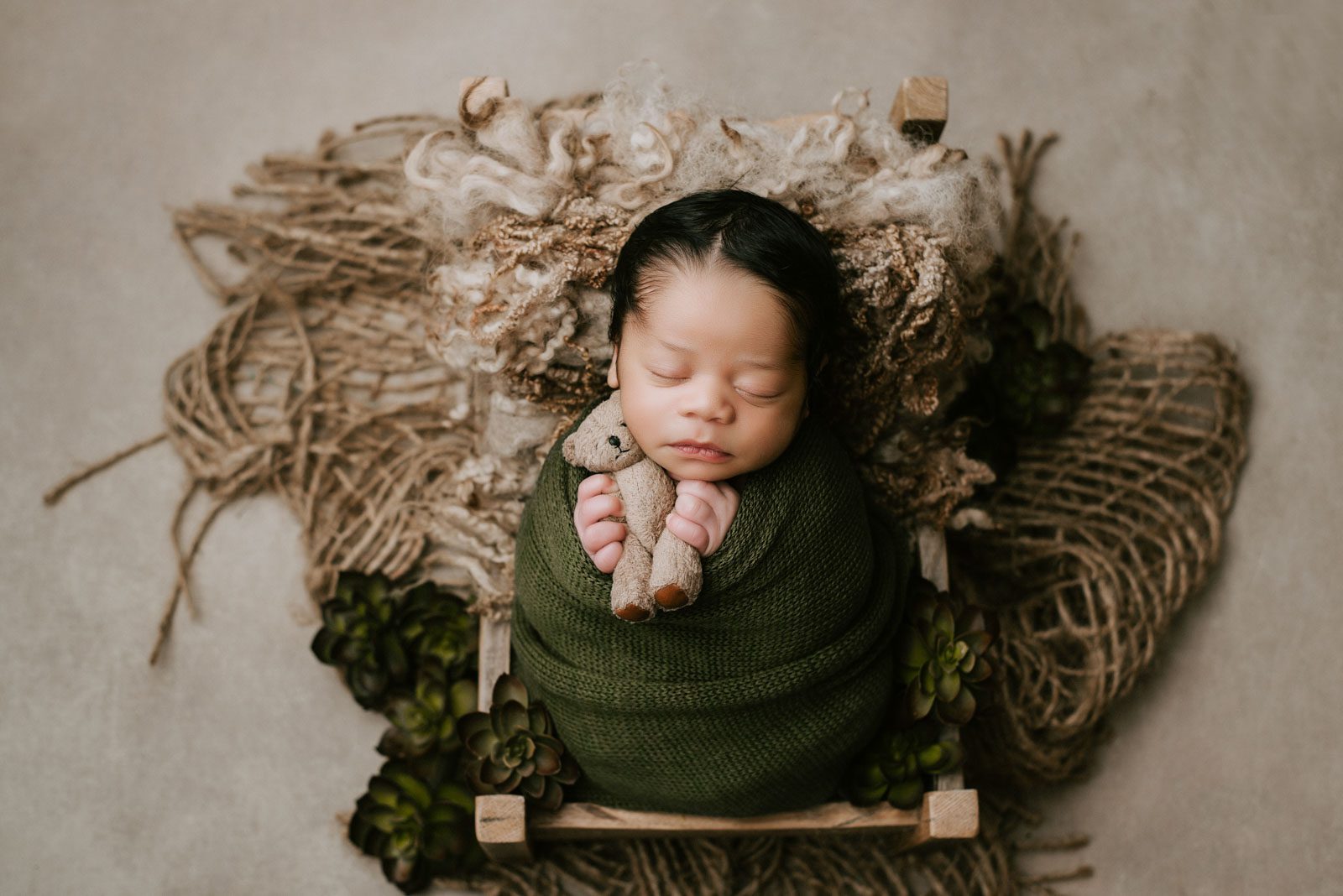 Sleeping Newborn Photographed In A Carefully Styled Portrait Setup