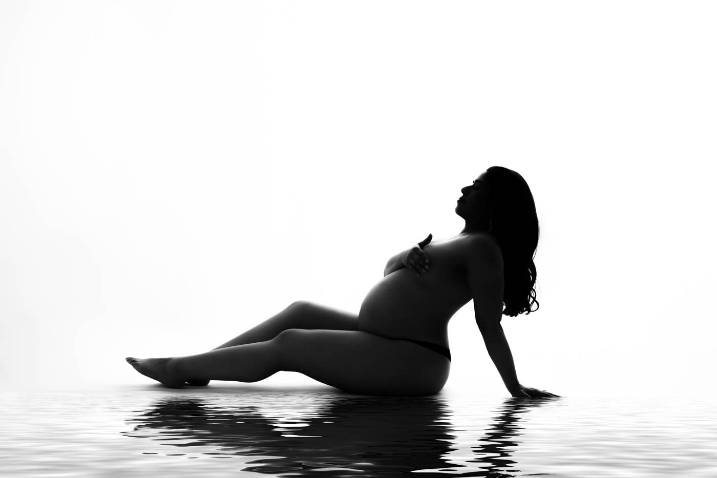 How To Pose Naturally For Maternity Photos In Dallas 1 Expecting Mother Posing During A Professional Maternity Photography Session