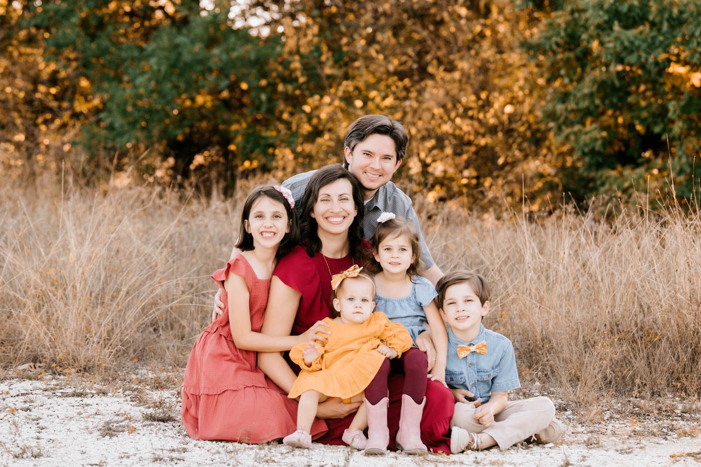 Family Portrait Featuring Coordinated Clothing And Seasonal Colors