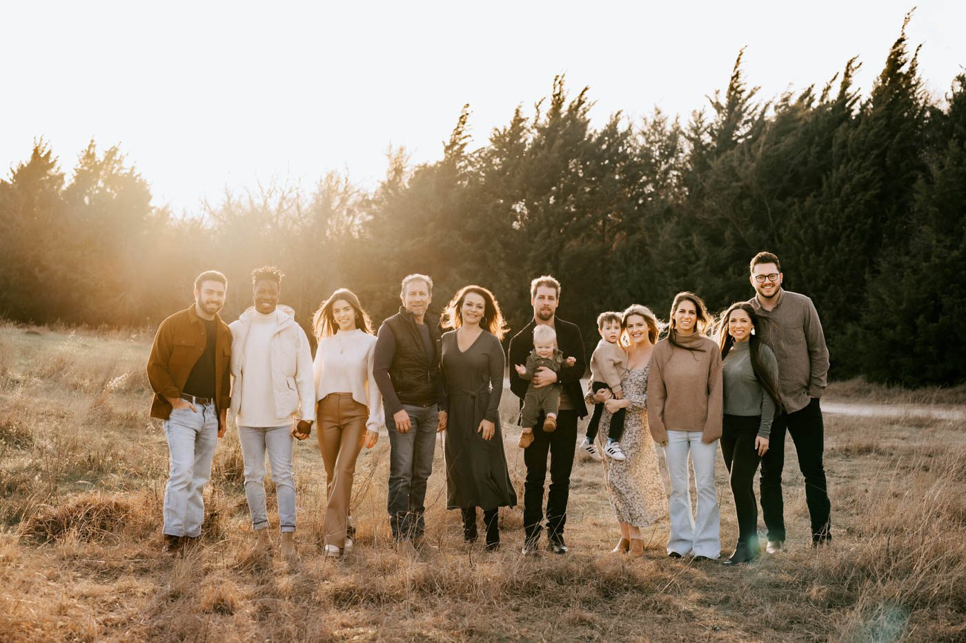 Extended Family Wearing Coordinated Outfits During An Outdoor Family Photography Session