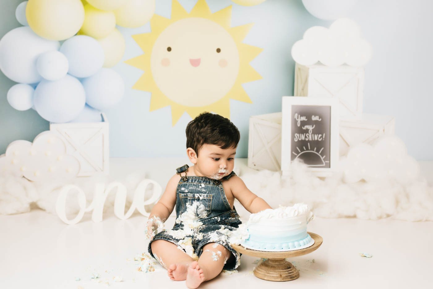Baby Boy Enjoying A Sunshine-Themed Dallas Cake Smash Photography Session For His First Birthday