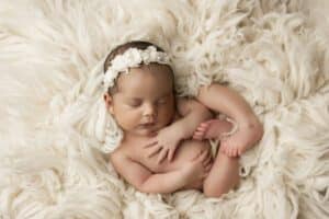 A Baby Sleeping On A Blanket For Dallas Newborn Photography