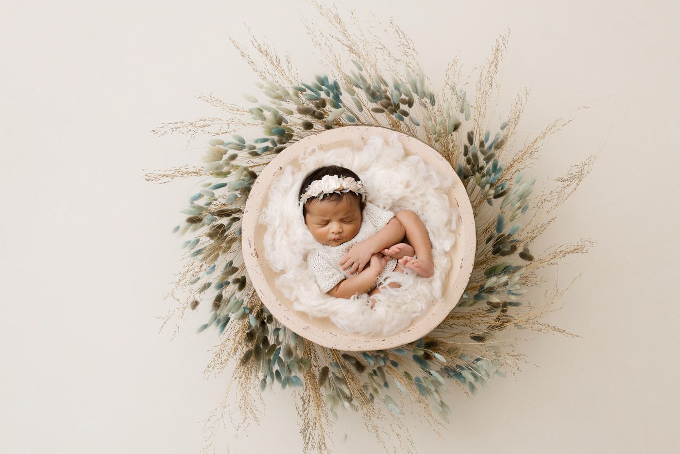 Why Professional Newborn Photography Matters For Dallas Families 1 Newborn Baby Posed In A Soft Nest With Neutral Tones And Natural Textures