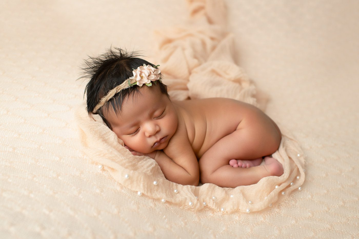 Why Professional Newborn Photography Matters For Dallas Families 2 Newborn Baby Wrapped In Cream Tones Resting Peacefully During A Studio Session