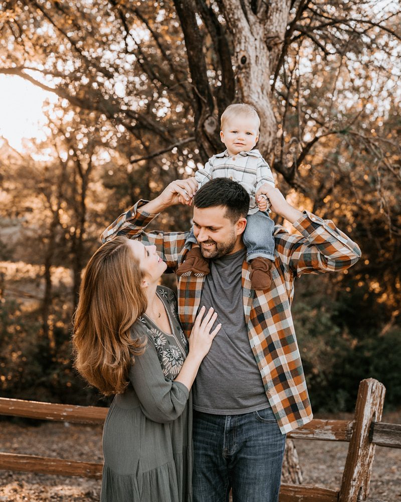 parents with baby boy smiling during a family photoshoot dallas