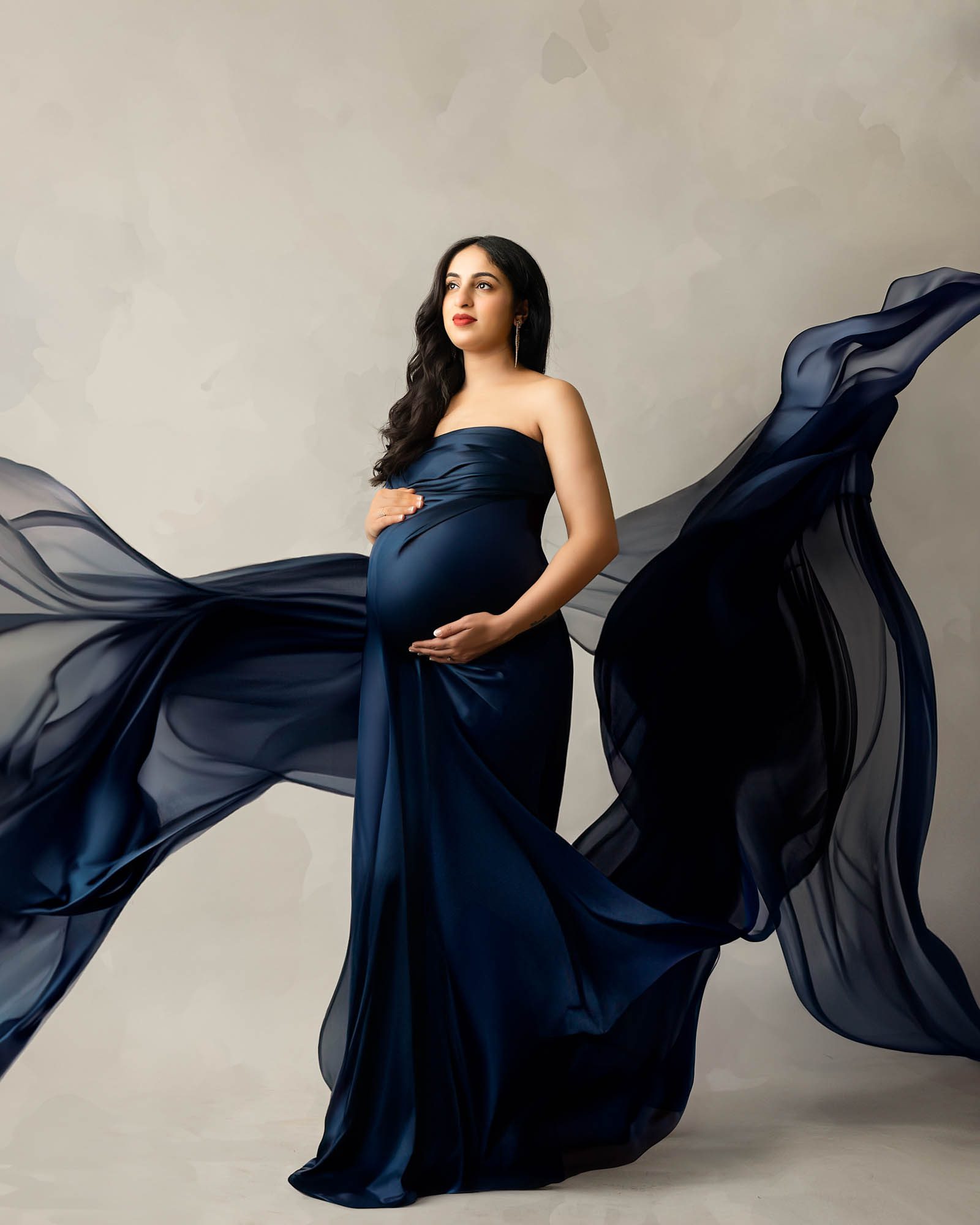 Elegant studio maternity portrait of expecting mother in navy blue dress captured by Dallas maternity photographer Lily Hayes Photography