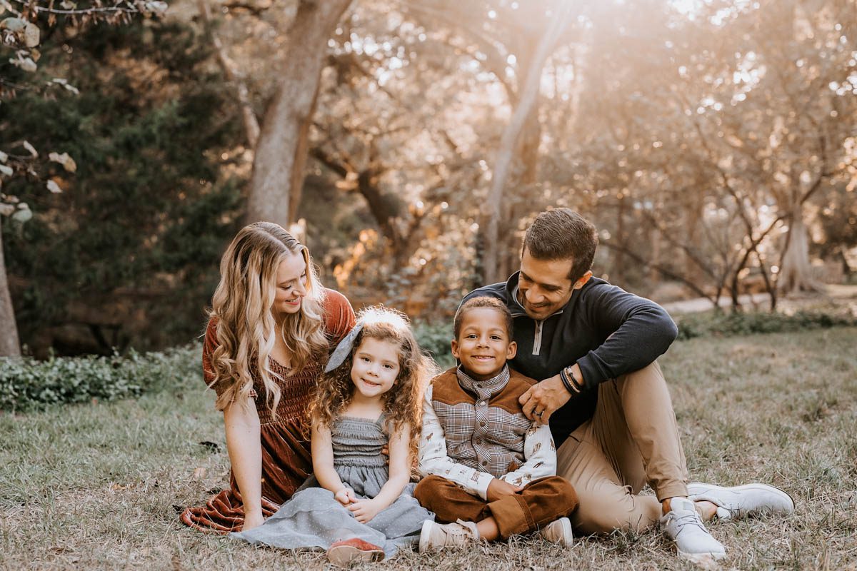 Dallas family photographer Lily Hayes Photography capturing a natural outdoor family portrait with parents and children in a warm, golden light setting.