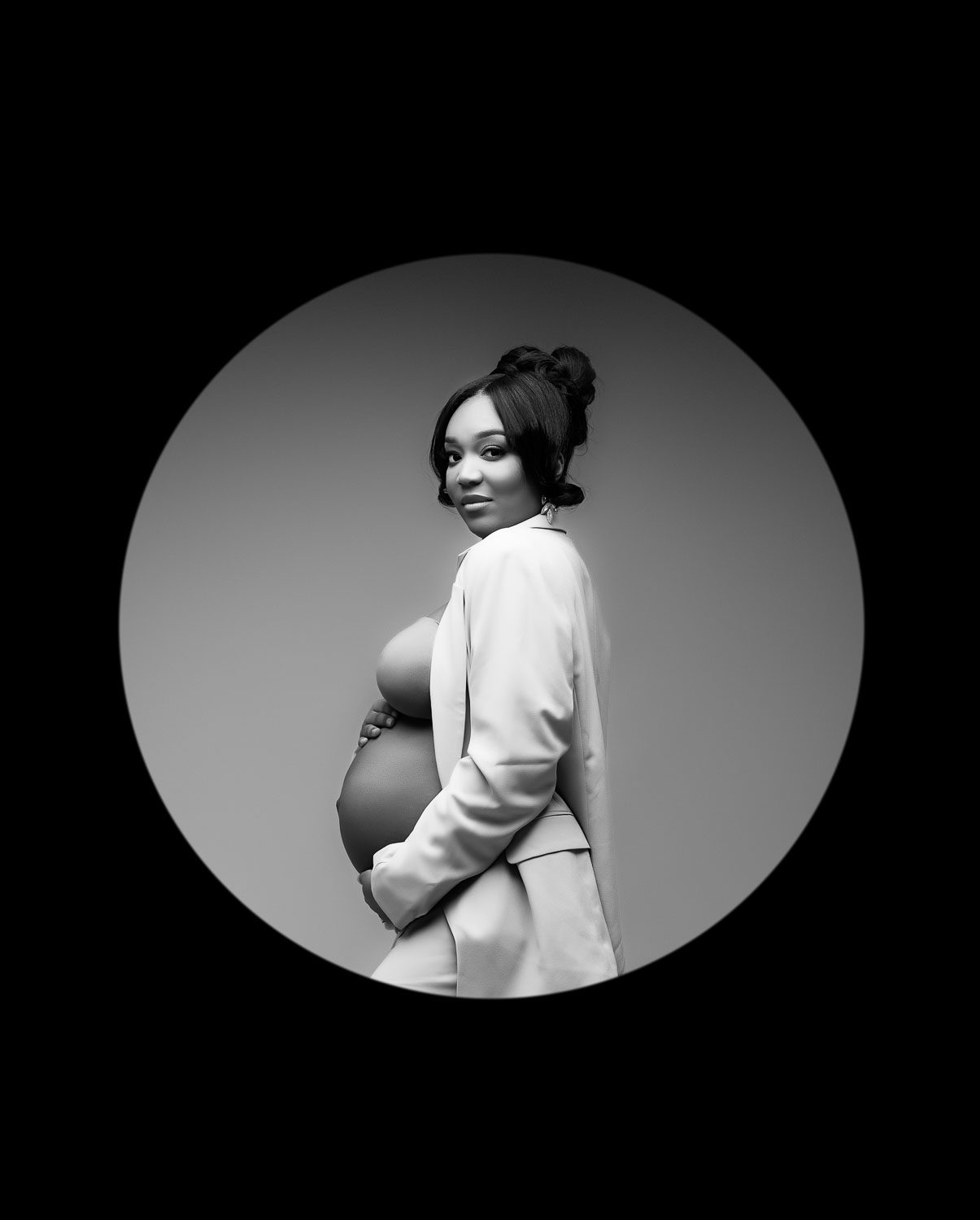 Black and white fine art studio portrait of an expecting mother photographed in Dallas