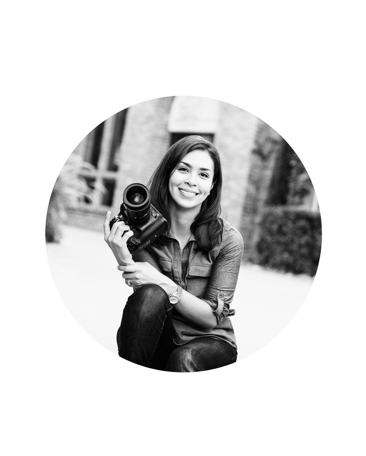 Lily Hayes, Dallas portrait photographer, holding her camera during an outdoor session