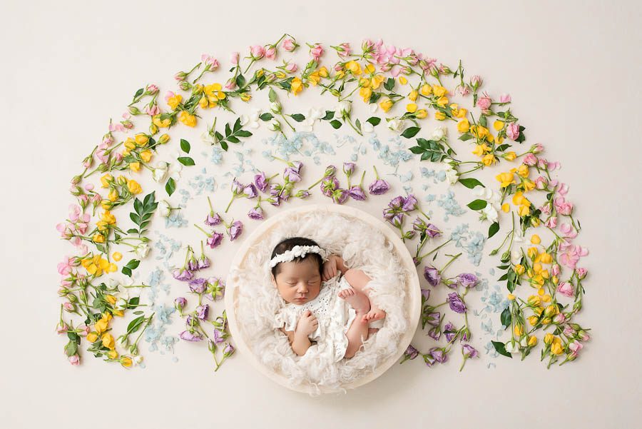 Sleeping Newborn Baby Photographed In A Floral Rainbow-Inspired Portrait Setup