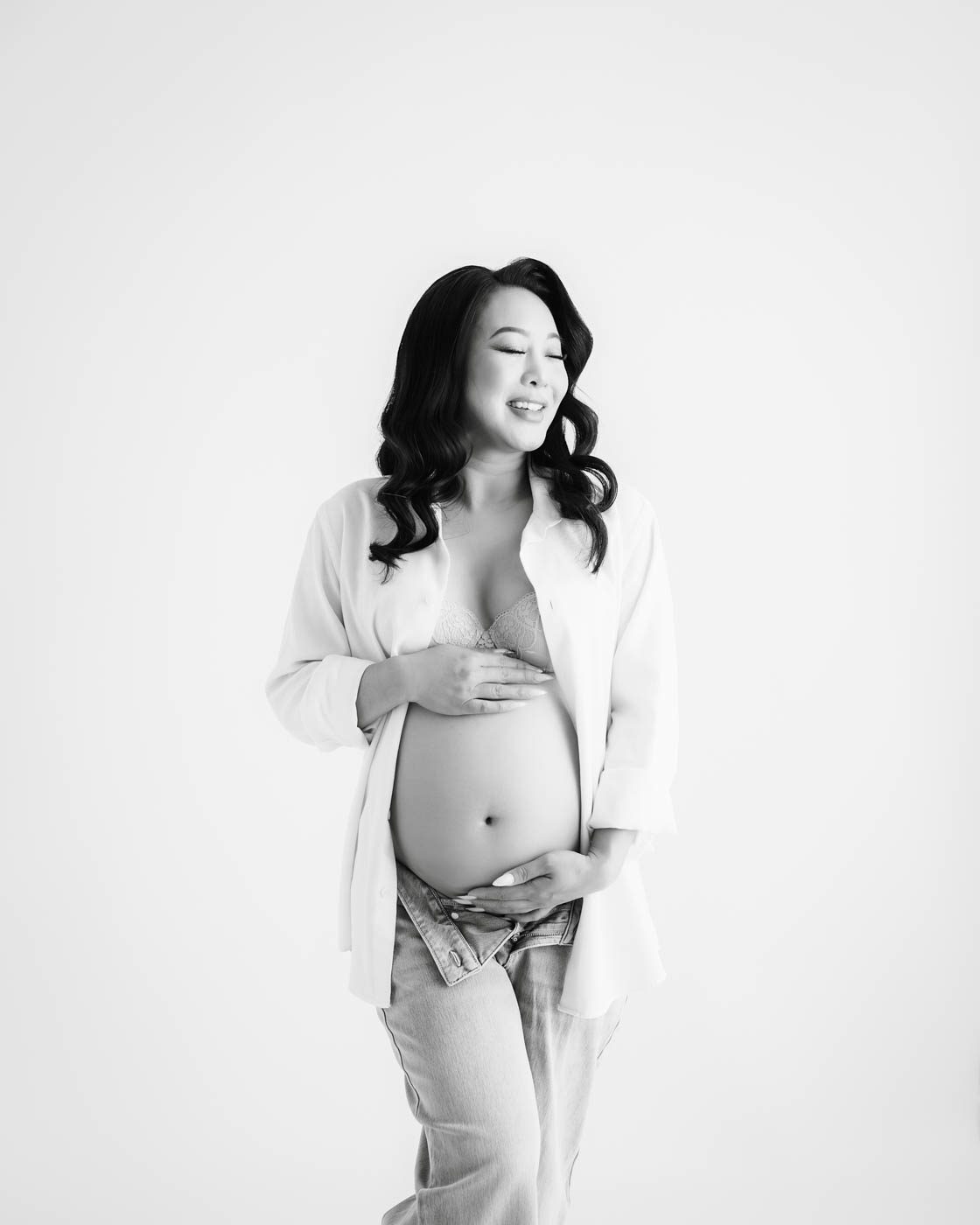 Expecting Mother Wearing Oversized White Shirt During Studio Maternity Photography Session