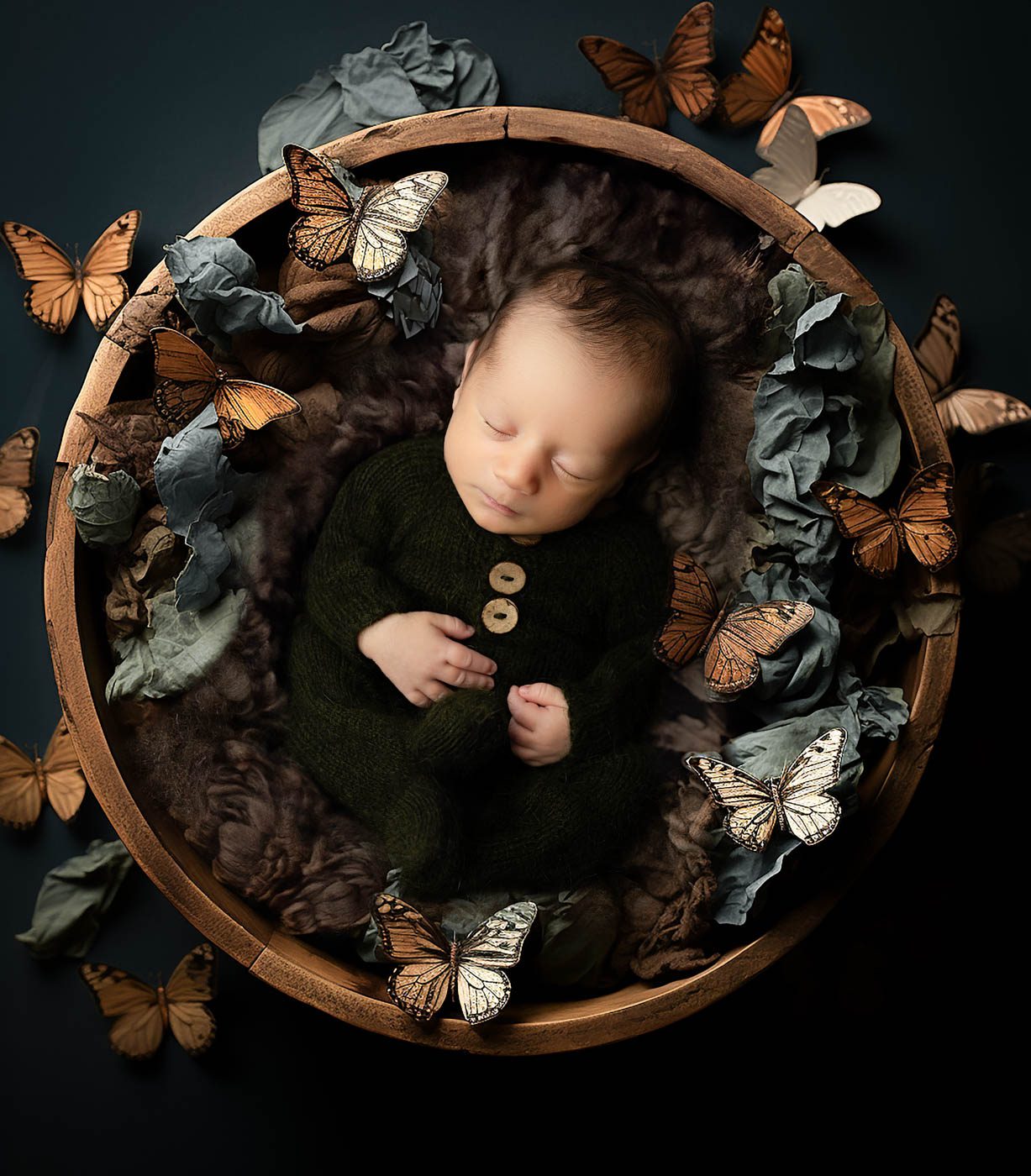 Sleeping Newborn In A Woodland-Inspired Bowl Surrounded By Earthy Textures During A Newborn Photography Session In Dallas.