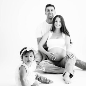 Family portrait from a Dallas studio maternity photography session featured alongside a five-star client review.