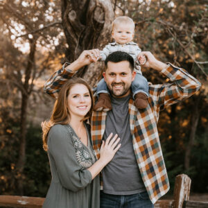 Young family with their toddler during an outdoor family photography session in Dallas featured with a five-star client review.