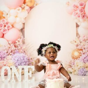 Baby girl celebrating her first birthday during a pink butterfly cake smash photography session in Dallas, featured with a five-star client review.