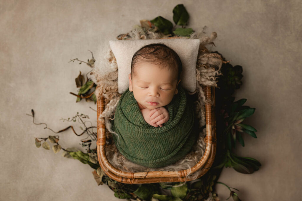 Newborn Safely Supported In A Basket During Professional Newborn Photography