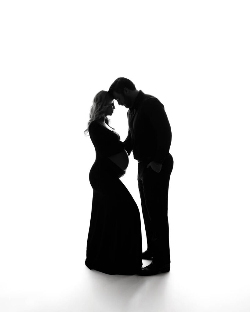Silhouette Portrait Of An Expecting Couple During A Studio Maternity Photography Session In Dallas