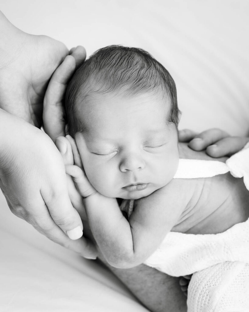 Fine Art Newborn Photography In Dallas Featuring A Close Portrait Of A Sleeping Newborn Baby
