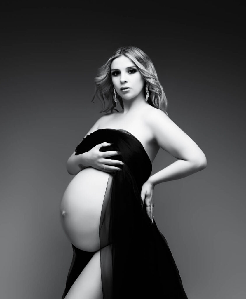 Maternity Photographer Dallas Portrait Of An Expectant Mother Posed In Dramatic Draped Black Fabric