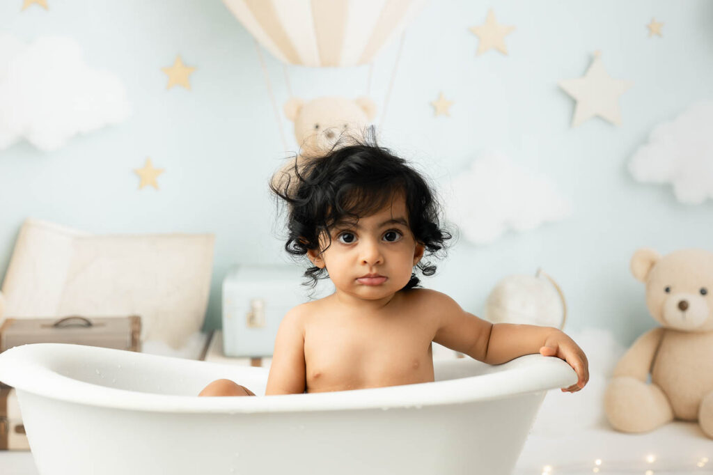 What Happens During A Dallas Cake Smash Session? From Portraits To Splash Bath 7 Baby Sitting In A White Tub During The Optional Splash Bath After A Dallas Cake Smash Session