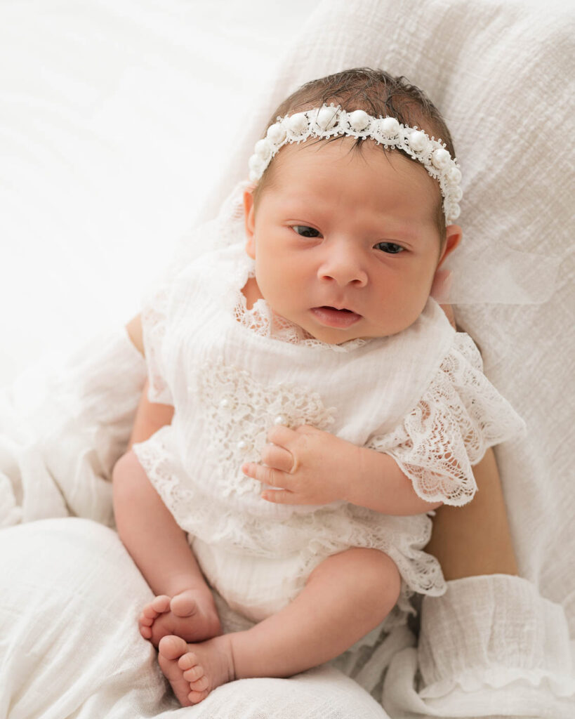 Awake Baby In White During A Newborn Photography Session In Dallas