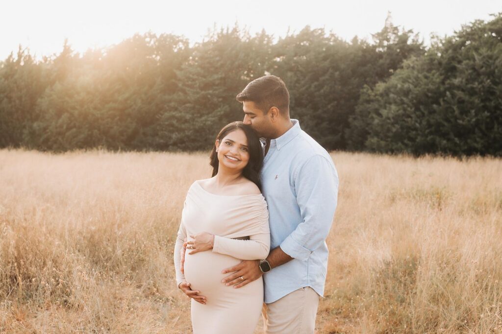 Maternity Photographer In Dallas Photographs Expecting Couple Together During A Relaxed Outdoor Maternity Photoshoot.