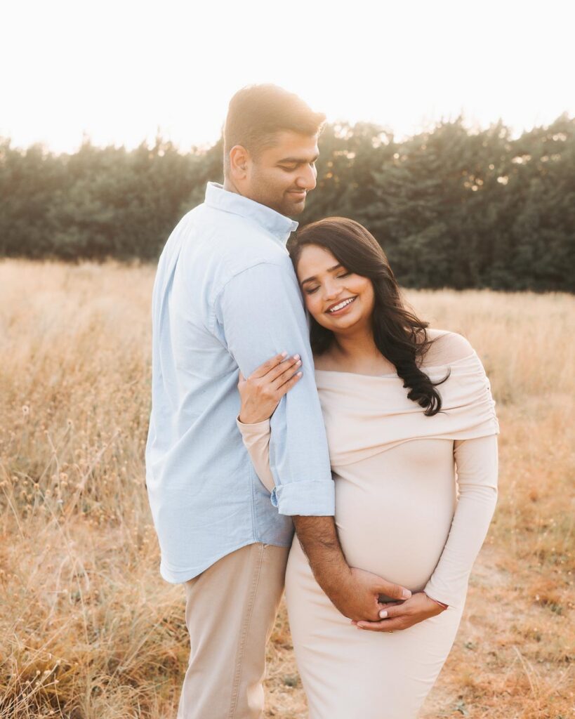 Maternity Photographer In Dallas Captures Expecting Mother Leaning Naturally Toward Her Partner During An Outdoor Session.