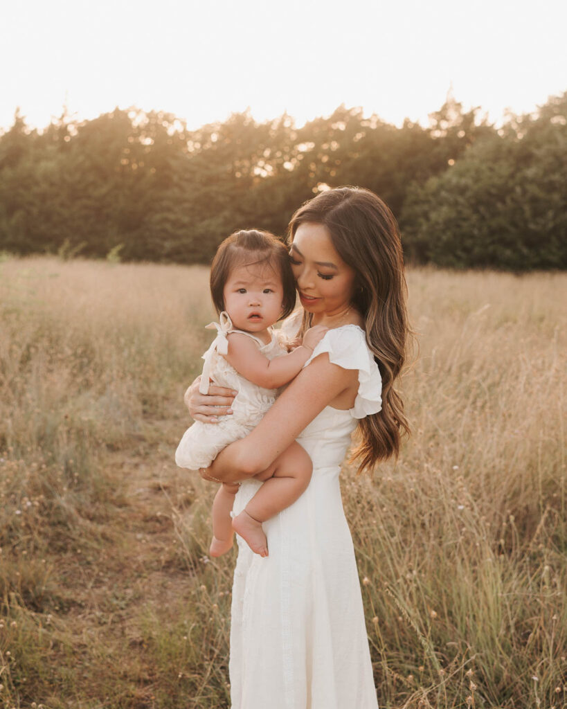 What If My Child Won’t Cooperate During Family Photos? 8 Mother Holds Her Toddler During Relaxed Outdoor Family Photos With Young Children In Dallas.