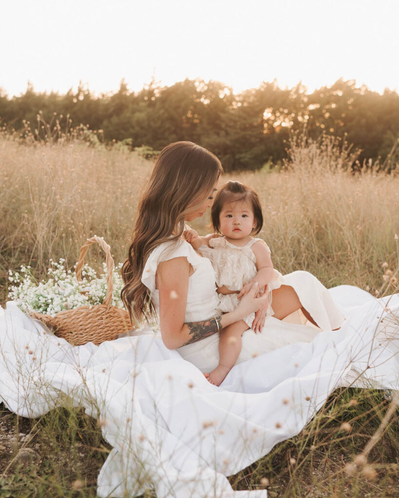 What If My Child Won’t Cooperate During Family Photos? 4 Mother Sits With Her Young Daughter On A Blanket During An Outdoor Family Session With A Toddler In Dallas.