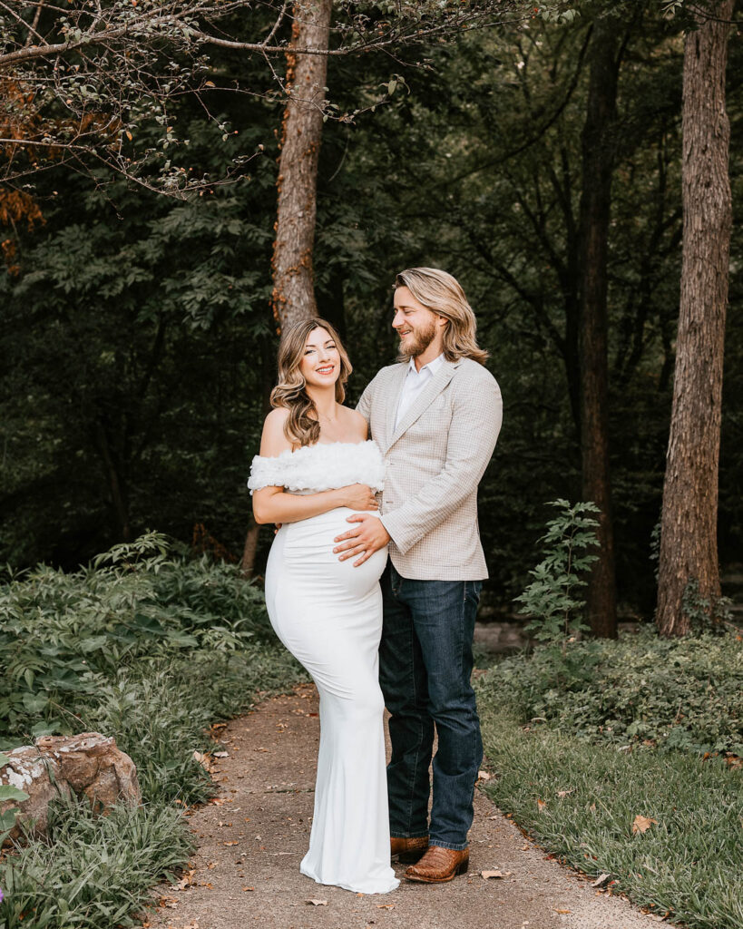Should Your Partner Be Included In Your Maternity Photos? 1 Dallas Maternity Photographer Portrait Of Expecting Mother In A White Gown Standing With Her Partner Outdoors