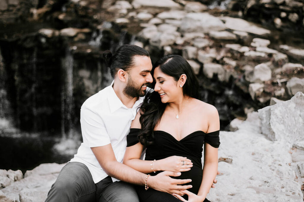 Should Your Partner Be Included In Your Maternity Photos? 3 Maternity Photographer Dallas Portrait Of Expecting Mother In A Black Dress Seated Closely With Her Partner