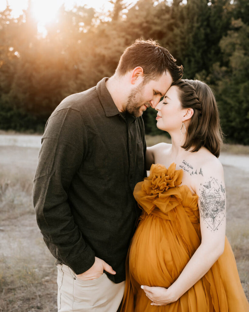Should Your Partner Be Included In Your Maternity Photos? 2 Maternity Photography Dallas Couple Portrait With Expecting Mother In A Mustard Gown Standing Closely With Her Partner