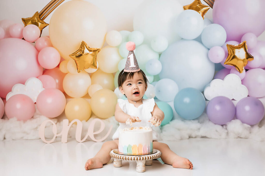 Baby Photographed With Pastel Balloons During A Cake Smash Photoshoot In Dallas
