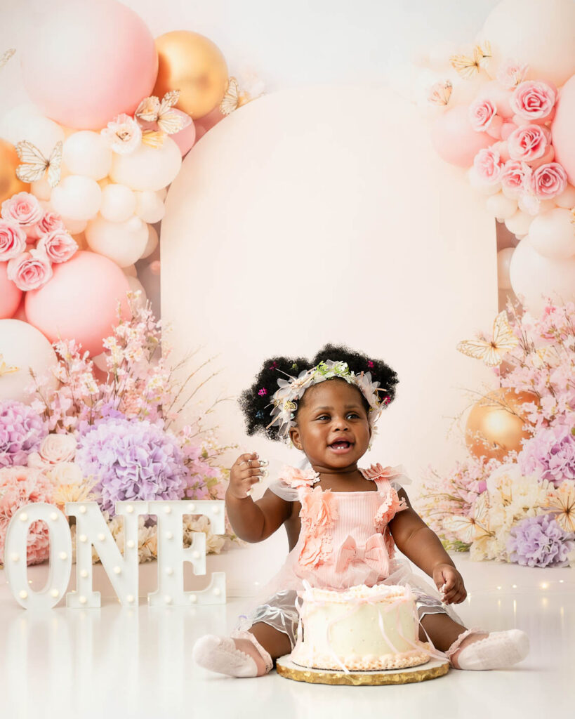 Baby Girl Photographed During A Pink Floral Dallas Cake Smash Photography Session
