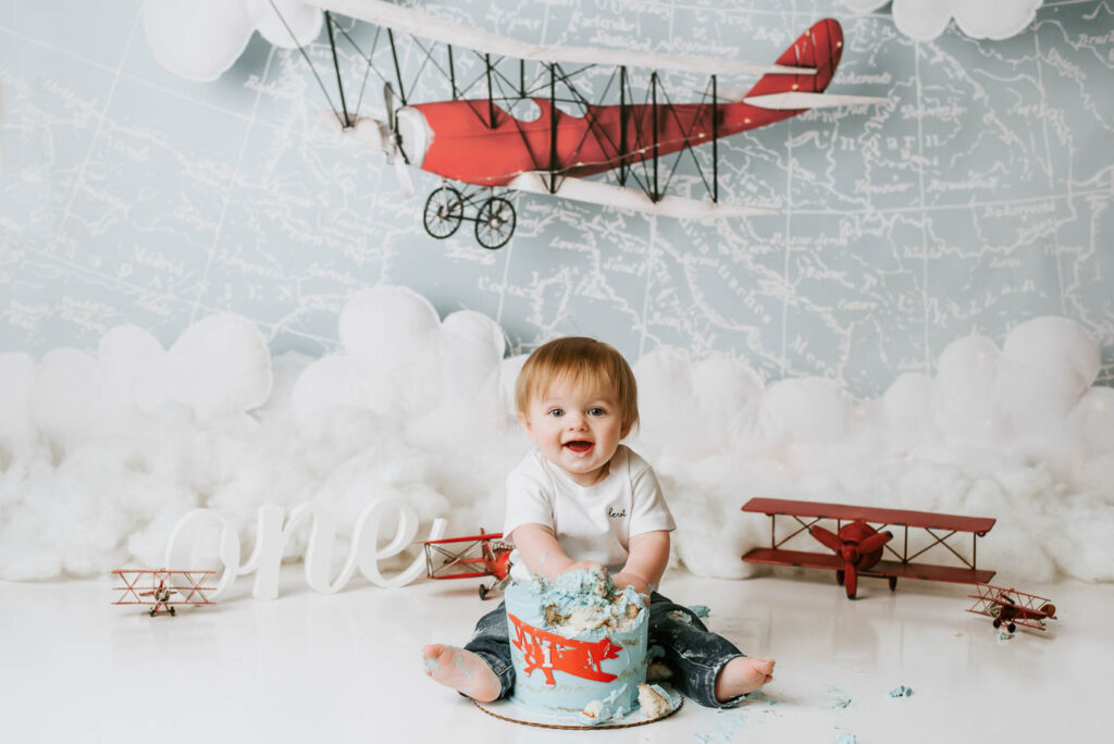 Baby Boy Photographed With An Airplane-Themed Cake Smash Setup In Dallas
