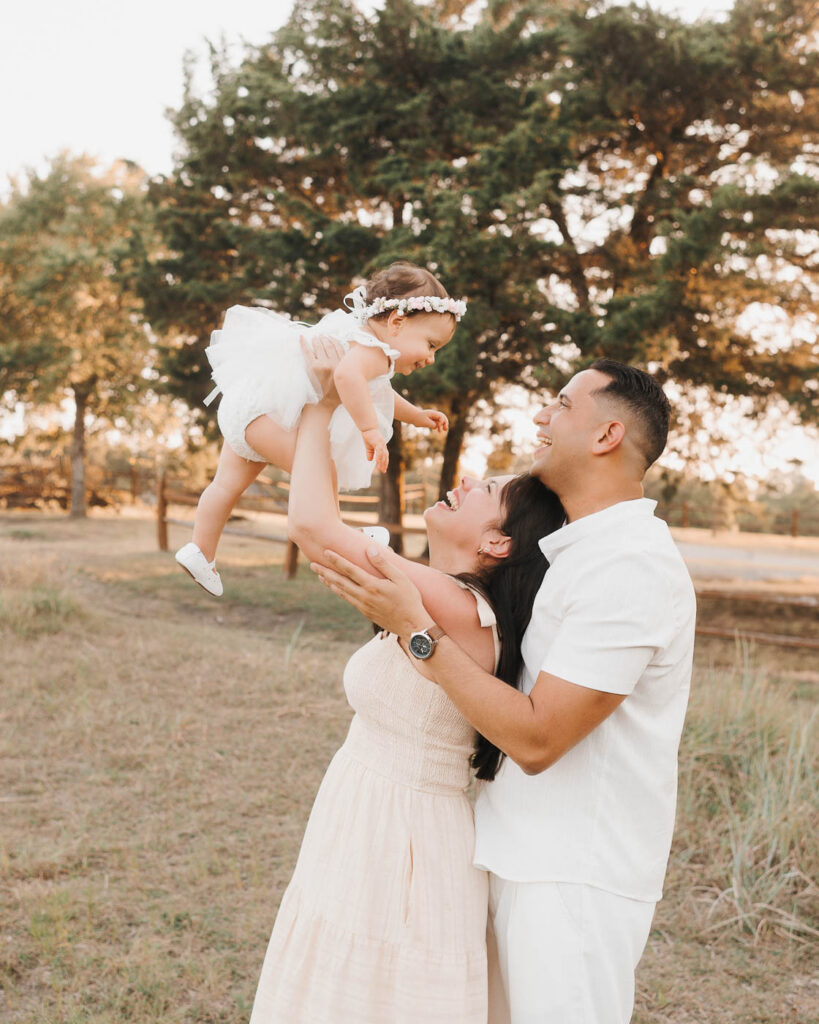How A Dallas Family Photographer Works With Young Kids Who Don’t Want To Sit Still 6 Parents Playing With Their Toddler During A Dallas Outdoor Family Photography Session.