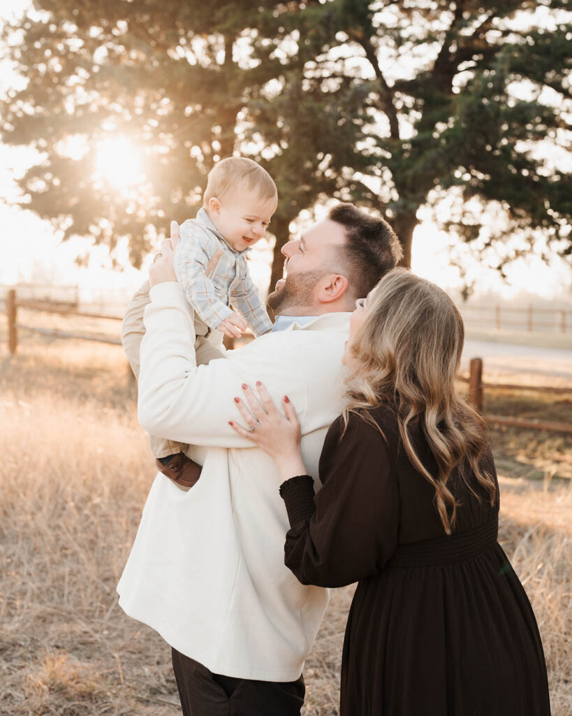 How A Dallas Family Photographer Works With Young Kids Who Don’t Want To Sit Still 4 Parents Interacting With Their Toddler During An Outdoor Family Photography Session In Dallas.