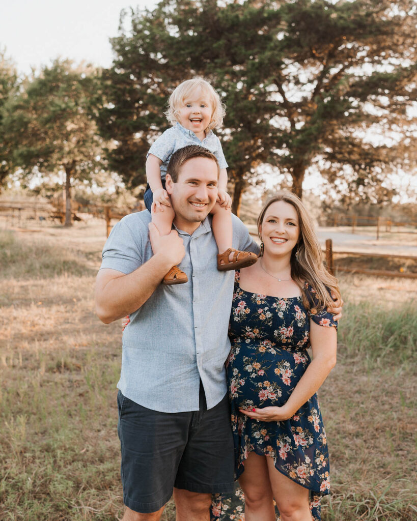 Maternity Photos With A Toddler: What Actually Works 1 Pregnant Mom With Her Partner And Toddler During An Outdoor Dallas Maternity Photography Session.