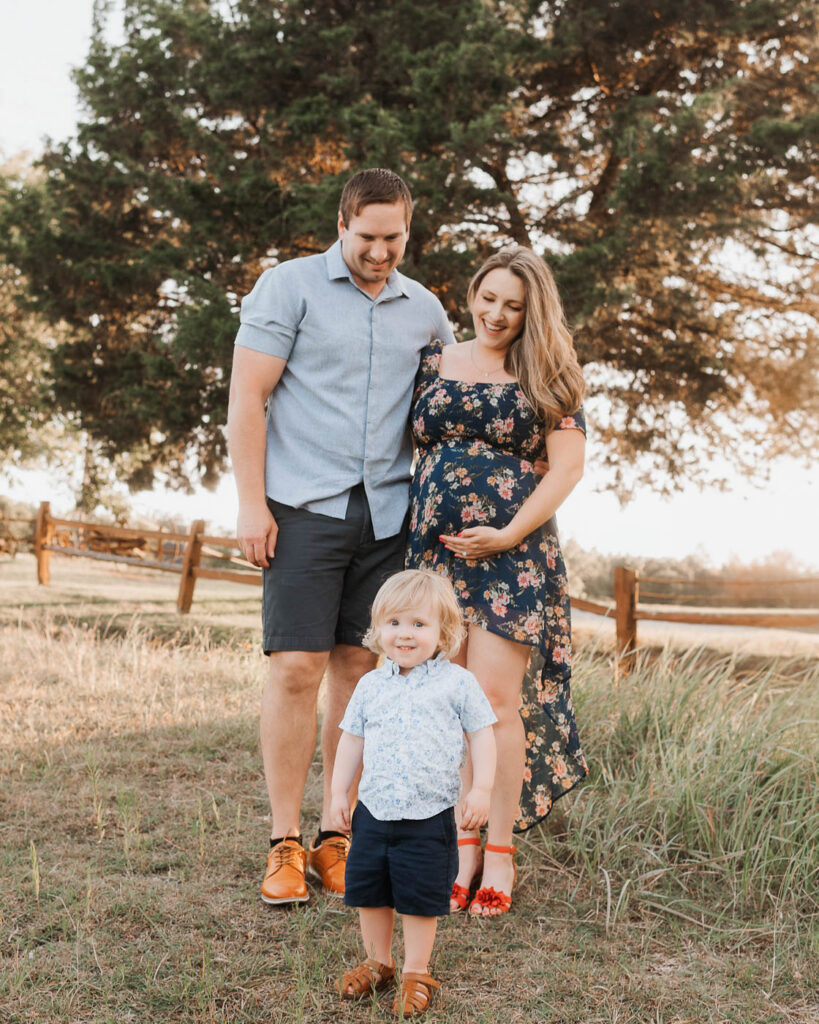 Maternity Photos With A Toddler: What Actually Works 6 Pregnant Mom And Dad Walking With Their Young Child During A Dallas Maternity Photography Session.