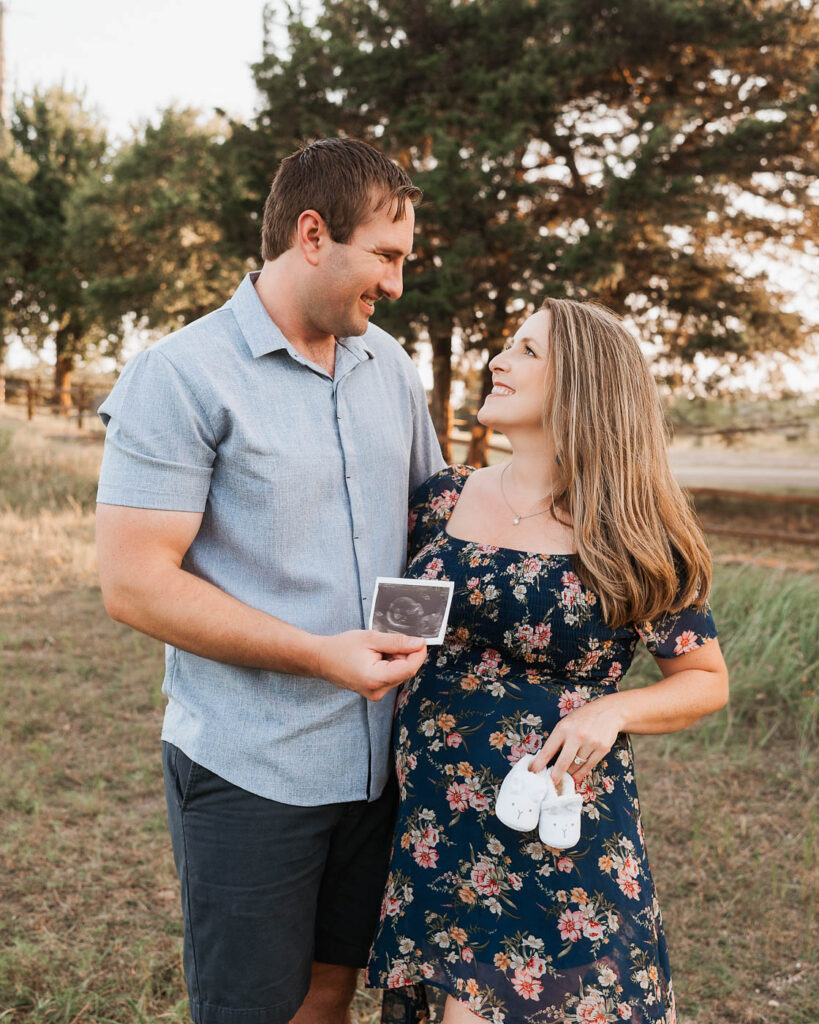 Maternity Photos With A Toddler: What Actually Works 4 Expecting Parents Standing Together During A Family Maternity Photoshoot In Dallas.